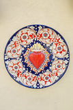 Grande piatto rotondo con cuore sacro in ceramica centrale