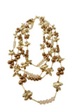 Collana a più fili in metallo dorato e perle ambrate