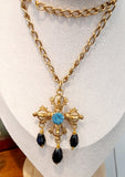 Collana croce con cristallo centrale in azzurro e pendenti in nero