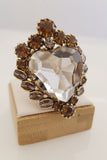 Anello cuore sacro con cristalli bianchi e ambrati