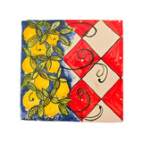 Mattonella in ceramica con volto di donna e decori carretto siciliano